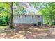Exterior of the home with sliding glass door, siding, and shady backyard at 1051 S Millard Way, Stone Mountain, GA 30088