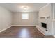 Basement space with vinyl flooring and a painted brick fireplace at 1051 S Millard Way, Stone Mountain, GA 30088