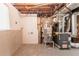 Unfinished basement features a water heater and furnace for essential home systems at 1051 S Millard Way, Stone Mountain, GA 30088