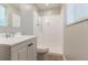 Bright bathroom with white vanity and a shower with a tiled wall at 1051 S Millard Way, Stone Mountain, GA 30088