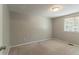 A bright bedroom with a window and light neutral carpet at 1051 S Millard Way, Stone Mountain, GA 30088