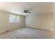Spacious bedroom with plush carpeting, a ceiling fan, and plenty of natural light at 1051 S Millard Way, Stone Mountain, GA 30088