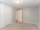 Bedroom with neutral walls, plush carpet, a closet, and a door to another room at 1051 S Millard Way, Stone Mountain, GA 30088
