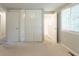 Bedroom with neutral walls, carpet, and large closet doors at 1051 S Millard Way, Stone Mountain, GA 30088