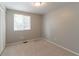 Bright bedroom with neutral walls, plush carpet, and a window letting in natural light at 1051 S Millard Way, Stone Mountain, GA 30088
