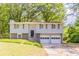 Charming two-story home with attached two-car garage and mature landscaping at 1051 S Millard Way, Stone Mountain, GA 30088