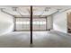 Spacious garage with white doors, concrete flooring and overhead lighting at 1051 S Millard Way, Stone Mountain, GA 30088