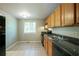 Bright kitchen with oak cabinets, a double sink, and views of the surrounding greenery at 1051 S Millard Way, Stone Mountain, GA 30088