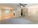 Open-concept living area with hardwood and carpet flooring, and large windows at 1051 S Millard Way, Stone Mountain, GA 30088
