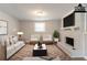 Staged living room with a fireplace and a sofa in a basement at 1051 S Millard Way, Stone Mountain, GA 30088