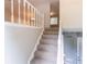 Carpeted staircase with a white railing leading to the upper level of the home at 1051 S Millard Way, Stone Mountain, GA 30088