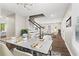 Bright dining room featuring a marble top table, modern lighting, and an open floor plan to the living room at 1911 Rollingwood Se Dr, Atlanta, GA 30316