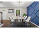 Chic dining room showcasing a modern light fixture, stylish chairs, and blue accent wall at 1911 Rollingwood Se Dr, Atlanta, GA 30316