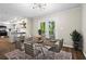 Dining room with seating for six, modern chandelier, and sliding glass doors to outside deck at 1911 Rollingwood Se Dr, Atlanta, GA 30316