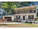 Charming two-story home with a gray and white painted brick exterior and double porches at 1911 Rollingwood Se Dr, Atlanta, GA 30316