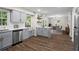 Bright kitchen with stainless steel appliances, grey cabinetry, ample countertop space, and hardwood floors at 1911 Rollingwood Se Dr, Atlanta, GA 30316