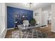 Modern office space featuring a geometric blue accent wall, stylish desk, and ample storage shelves at 1911 Rollingwood Se Dr, Atlanta, GA 30316