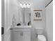 Clean bathroom with stylish vanity, modern lighting, and decorative wall art at 300 Olmstead Way, Alpharetta, GA 30022