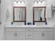 Double vanity bathroom featuring white cabinets, quartz countertops and framed mirrors at 300 Olmstead Way, Alpharetta, GA 30022