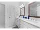 Double vanity bathroom featuring white cabinets, quartz countertops and framed mirrors at 300 Olmstead Way, Alpharetta, GA 30022