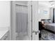 Ensuite bathroom with a shower and a view into the cozy bedroom at 300 Olmstead Way, Alpharetta, GA 30022