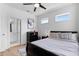 Comfortable bedroom with neutral gray color scheme, a large bed, and hardwood floors at 300 Olmstead Way, Alpharetta, GA 30022