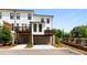 Well-maintained townhome featuring private balconies, garages, and landscaped yard at 300 Olmstead Way, Alpharetta, GA 30022