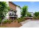 Beautiful townhome with private balconies, landscaping, and communal outdoor seating area at 300 Olmstead Way, Alpharetta, GA 30022