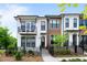 Attractive townhome with a painted brick facade, upper balcony and front yard landscaping at 300 Olmstead Way, Alpharetta, GA 30022