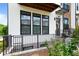 Charming white brick townhome with a lovely front porch and black railings at 300 Olmstead Way, Alpharetta, GA 30022