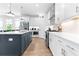 Kitchen with white cabinets, stainless steel appliances, subway tile backsplash, and center island with seating at 300 Olmstead Way, Alpharetta, GA 30022