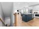 Open concept kitchen with island seating and stainless appliances, seamlessly connected to the living space at 300 Olmstead Way, Alpharetta, GA 30022
