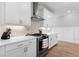 Kitchen has a stainless steel range hood with white cabinets, and plenty of countertop space at 300 Olmstead Way, Alpharetta, GA 30022