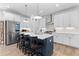 Bright kitchen with stainless steel appliances, white countertops, and island with dark blue cabinetry at 300 Olmstead Way, Alpharetta, GA 30022