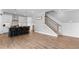 Modern living area with a view of the kitchen and a hardwood staircase at 300 Olmstead Way, Alpharetta, GA 30022