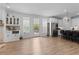 Bright living room with open floor plan to kitchen, bar, and stainless appliances at 300 Olmstead Way, Alpharetta, GA 30022