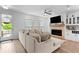 Bright living room with a fireplace, built-in bar, and a comfortable couch at 300 Olmstead Way, Alpharetta, GA 30022