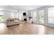 Bright living room features a fireplace, bar, and outdoor access to the deck at 300 Olmstead Way, Alpharetta, GA 30022