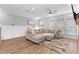 Living room with ample natural light, a cozy sectional, and hardwood floors at 300 Olmstead Way, Alpharetta, GA 30022
