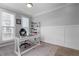Bright home office with a modern white desk, plush rug, and natural light from a pair of windows at 300 Olmstead Way, Alpharetta, GA 30022
