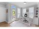Bright home office with a modern white desk, plush rug, and natural light from a glass door to the outside at 300 Olmstead Way, Alpharetta, GA 30022