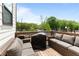 Inviting outdoor patio with comfortable cushioned seating, a grill, and scenic views of the surrounding landscape at 300 Olmstead Way, Alpharetta, GA 30022