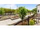 Outdoor patio with black railing overlooking manicured grounds with lush greenery and walking paths at 300 Olmstead Way, Alpharetta, GA 30022