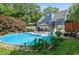 This backyard features a large pool, deck, lounge chairs, and lush landscaping at 68 Edwin Pl Nw, Atlanta, GA 30318