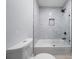 This bathroom features a white tub with a shower and a clear glass door at 68 Edwin Pl Nw, Atlanta, GA 30318