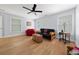 This bedroom features hardwood floors, two windows, and a ceiling fan at 68 Edwin Pl Nw, Atlanta, GA 30318
