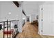 This hallway features hardwood floors, exposed beams, and wrought iron railing at 68 Edwin Pl Nw, Atlanta, GA 30318