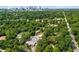 Aerial view of property featuring pool, tree canopy, and city skyline at 718 Province Se Pl, Atlanta, GA 30312
