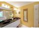 Bathroom featuring double sinks, vanity with granite countertop, and walk-in shower at 718 Province Se Pl, Atlanta, GA 30312