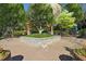 Community courtyard with brick walkway, stone planter, and mature landscaping at 718 Province Se Pl, Atlanta, GA 30312